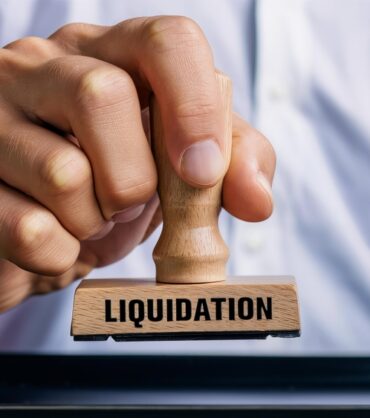 Hand,Holding,A,Rubber,Stamp,That,Says,Liquidation